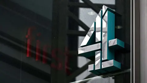 Getty Images A file photo shows the Channel 4 logo on the side of a building at the headquarters of the broadcaster, draped in shadow on a cloudy day.
