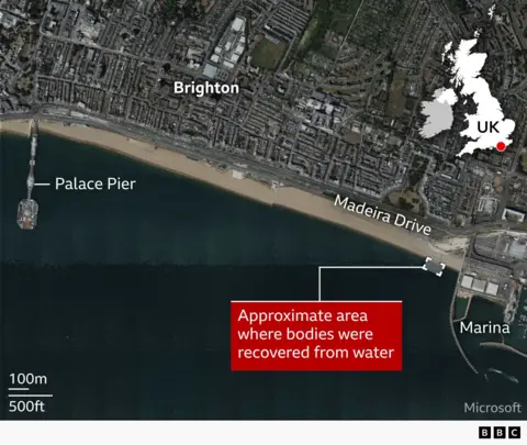 A satellite map of Brighton seafront in the UK showing the coastline, with labels for “Brighton,” “Palace Pier,” “Madeira Drive,” and “Marina.” A red box highlights the approximate area offshore where bodies were recovered from the water, east of the pier near the marina. A small inset map of the UK marks the location in southern England, and a scale bar indicates distance.